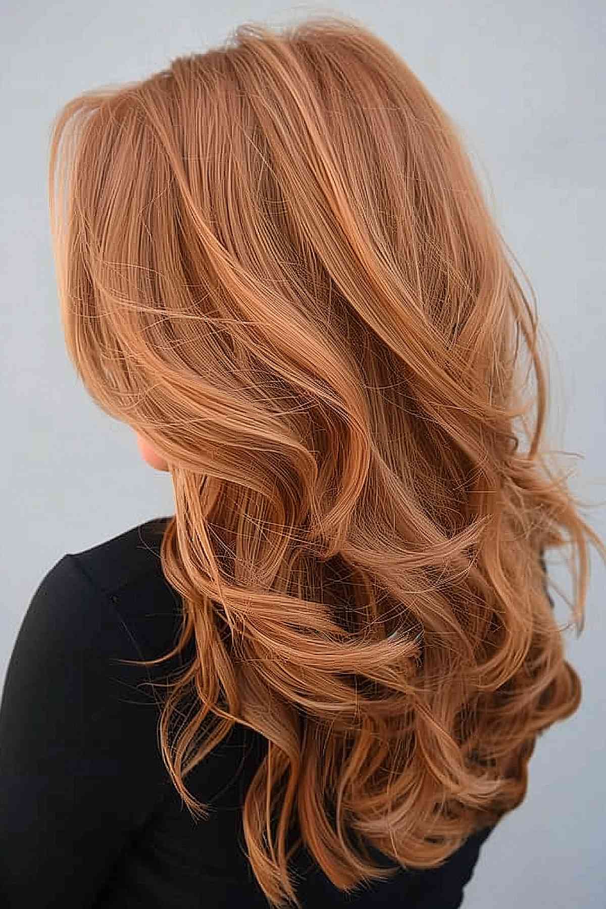 Faded ginger copper color on long, wavy hair