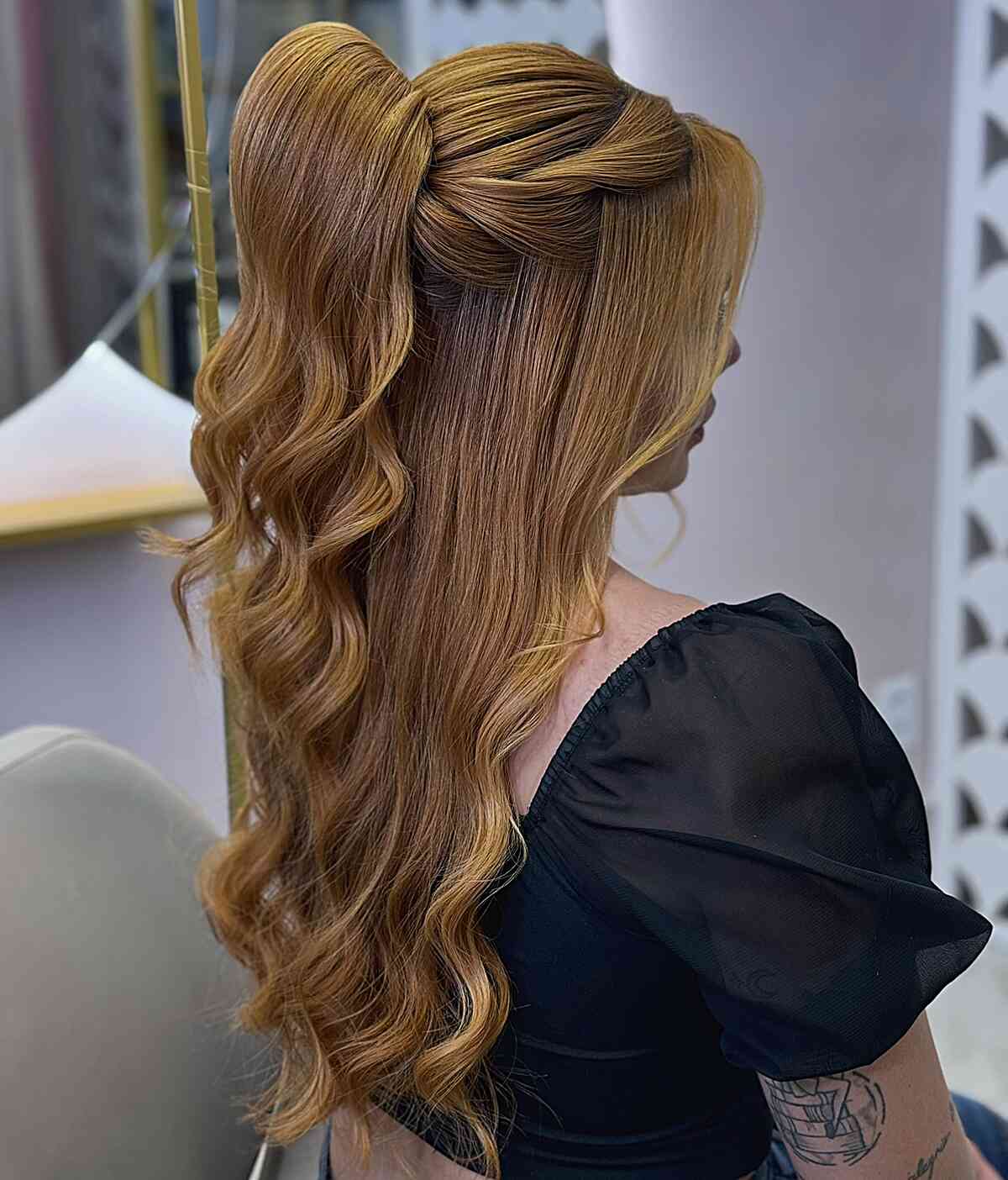 Half-up gala hairstyle with soft, wavy ends