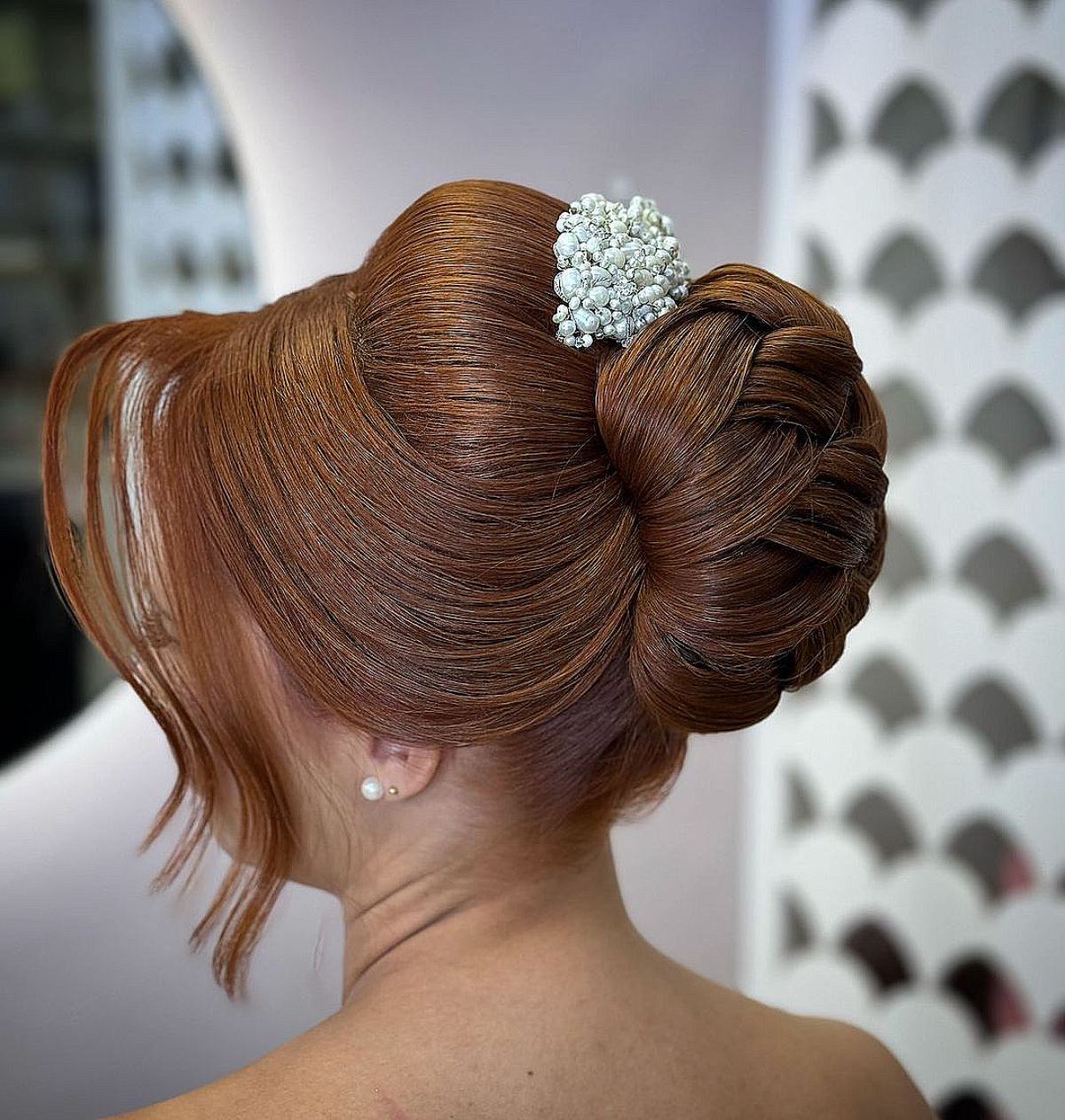 Elegant and unique layered bun with long fringe for a gala evening