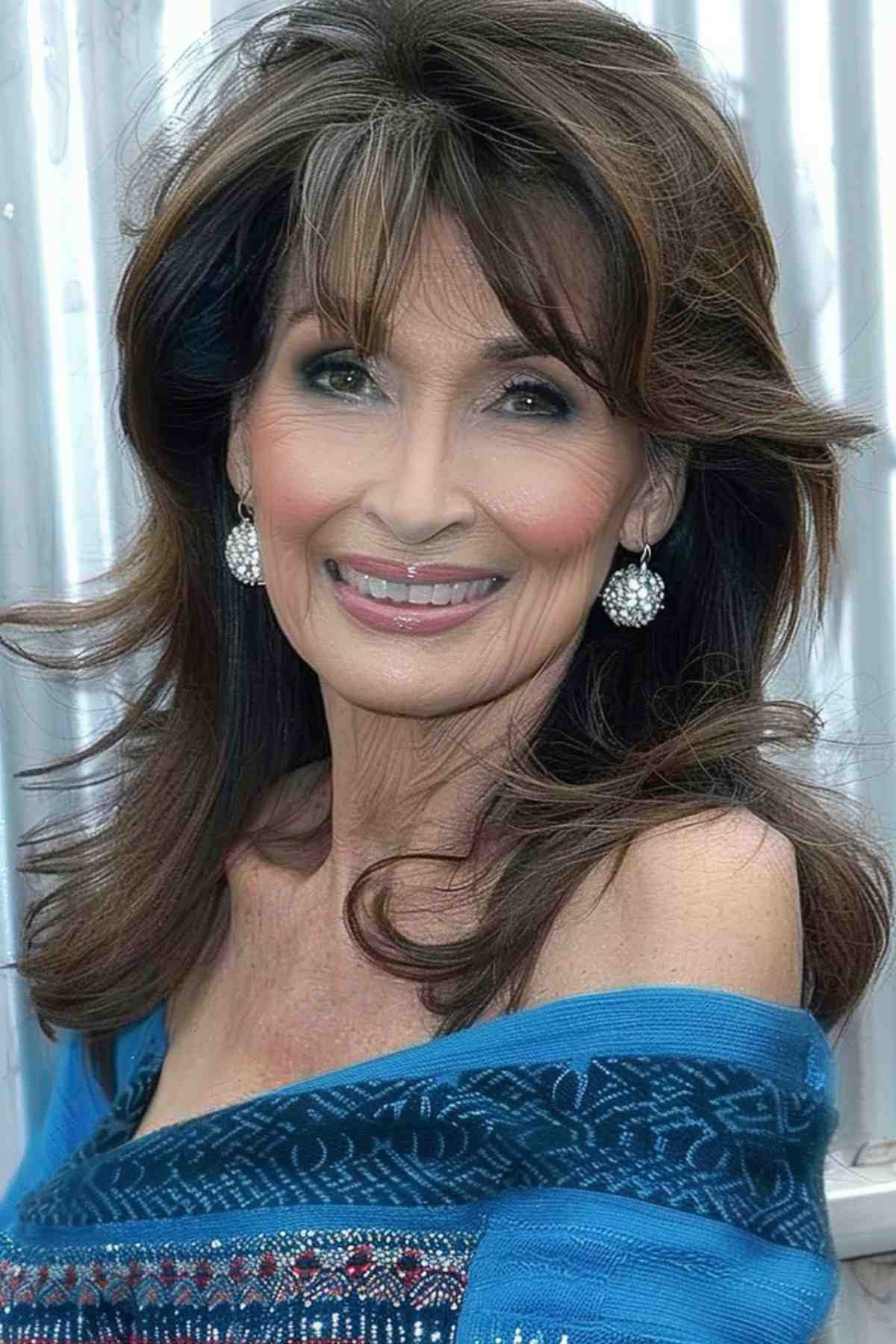 Smiling woman with long brown hair and light bangs creating a soft, face-framing effect.