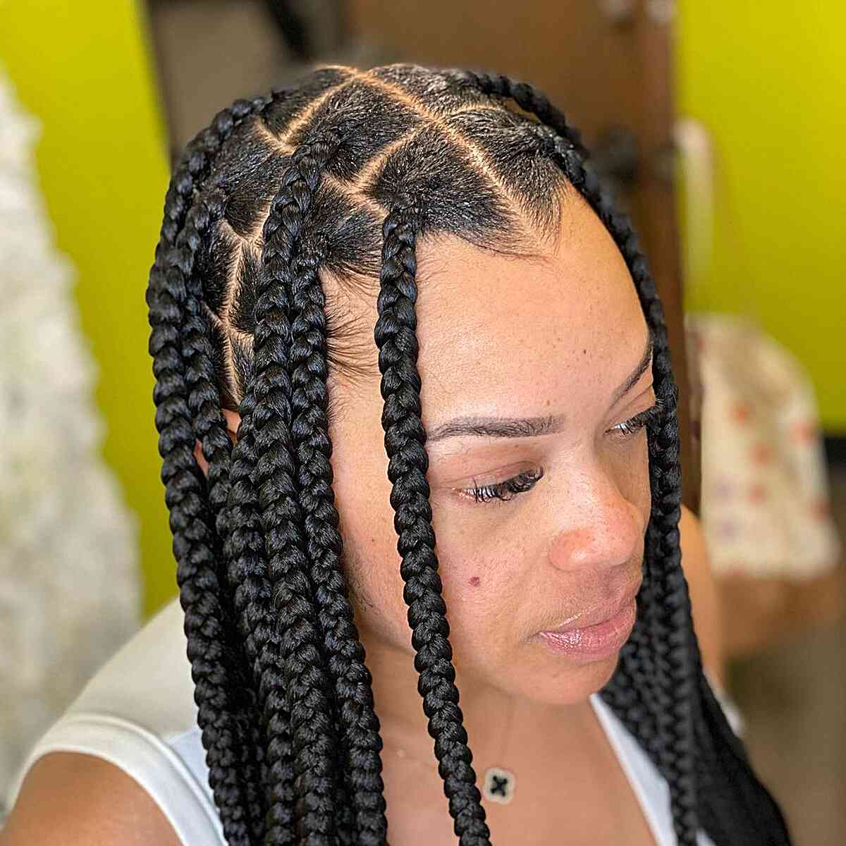 Large knotless braid with center parting to frame the face