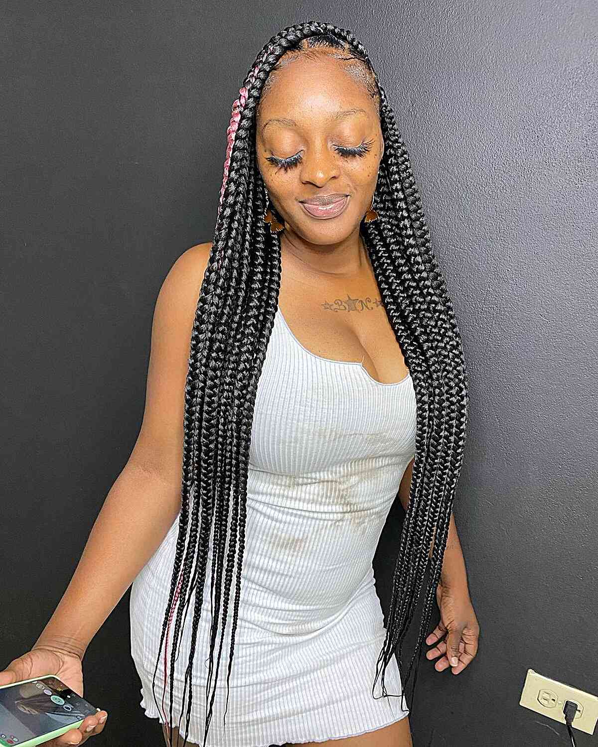 Very long, knotless braids with a pink accent for natural black hair