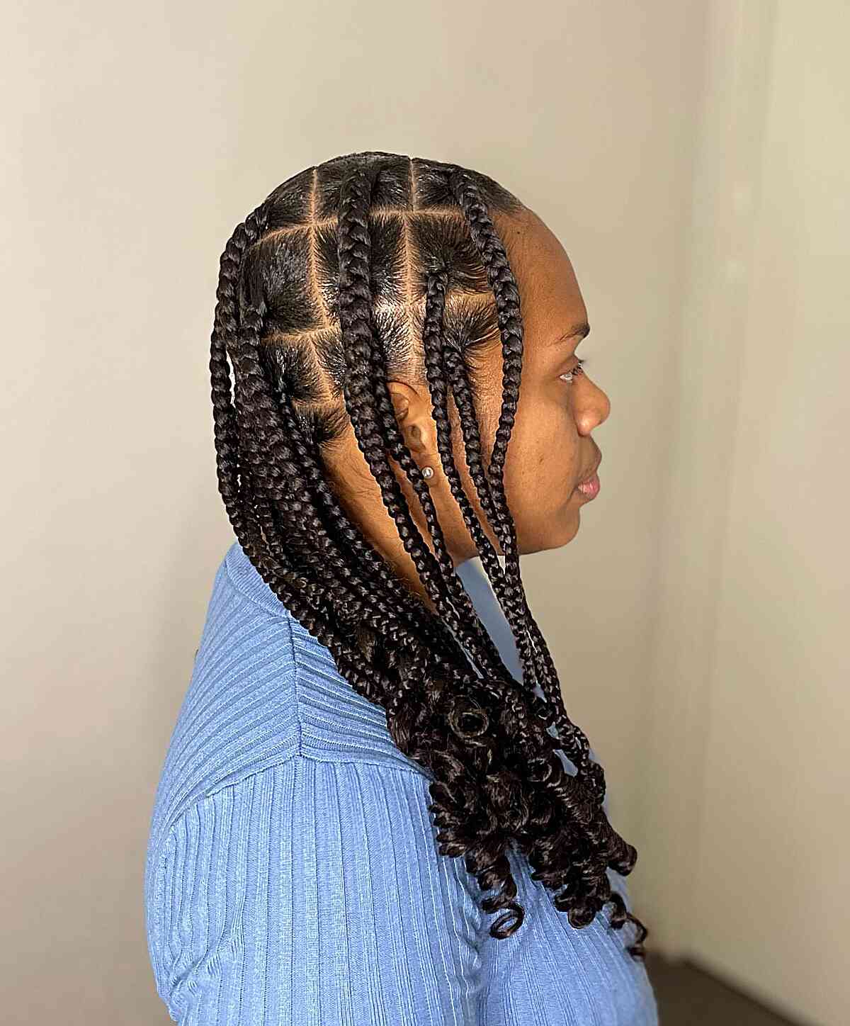 Medium-length knotless braids with spiral curls